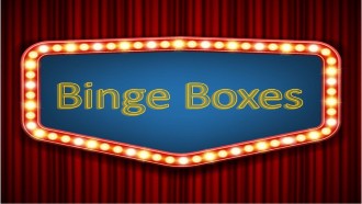 Binge boxes text on a marquee on red curtains