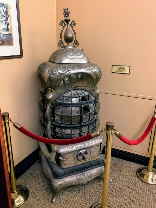 Photograph of the Favorite Base Burner coal stove on the first floor of the Piqua Public Library.