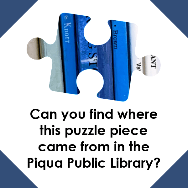 A graphic with a white background and navy blue corners. There is a puzzle piece with different shades of blue stripes on it in the center. Black text under the puzzle piece reads "Can you find where this puzzle piece came from in the Piqua Public Library?"